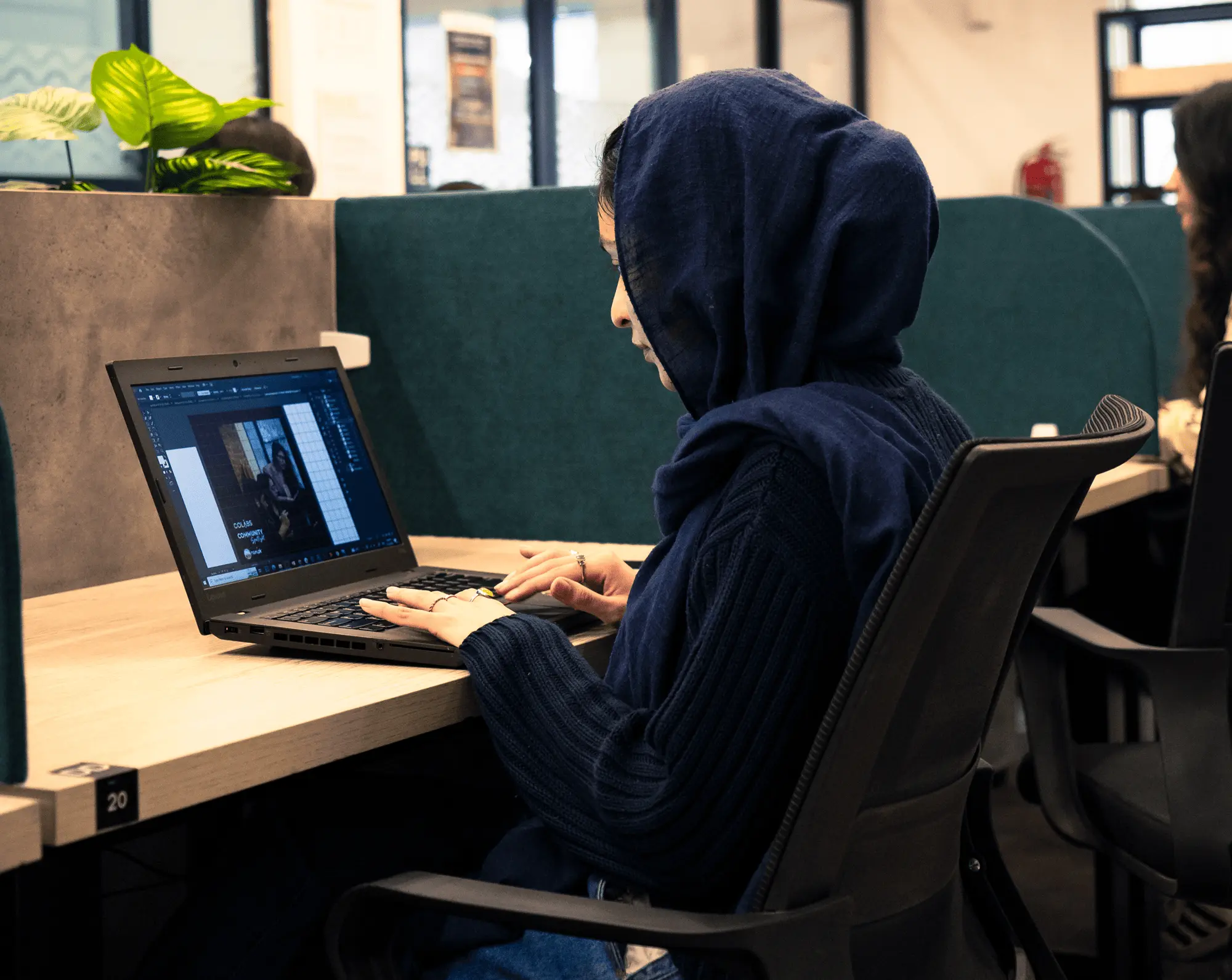 DigiNeom engineer working at a provisioned desk in a managed workspace
